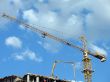 Yellow tower crane on a construction site