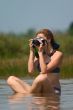 girl with camera in water