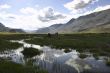 Mauntain landscape with horses and cloudy sky