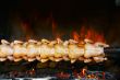 Broiling chicken on spit