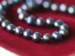 Black pearl necklace on red velvet
