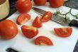 Slicing tomatoes into wedges for a salad