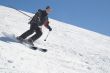Skier with ski pole on snow and blue sky
