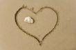 drawing heart on sea sand