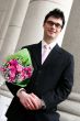 Happy man with flowers under his arm