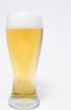A pilsner glass of ice cold beer.