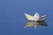 a paper boat floating in a lake