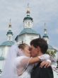 Newlyweds couple kissing upon cathedral