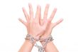 two hands with chain isolated on white