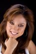 Brunette smiling with fist on chin
