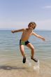 Child jump on seacoast