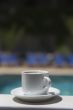 cup coffee on background of the pool