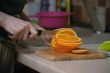 Knife cutting vegetables on kitchen table.