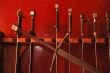 Swords against red wall.