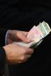 Male hands counting different money banknotes