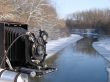 Ancient photo camera shoting snowy riverside