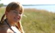 A merry girl is spectacled near a sea