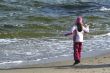 The girl plays with a wave