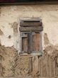 Alone window of aged ruined urban building