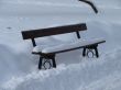 Snowy winter town square bench