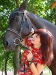 Brunette female model with black horse