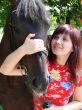 Brunette female model with black horse