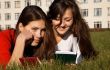 Girls reading the books on the lawn