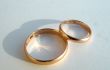 Two wedding gold rings on white background