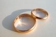 Two wedding gold rings on white background