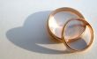 Two wedding gold rings on white background