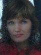 Girl looks thru waterdropped widow glass