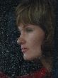 Girl looks thru waterdropped widow glass