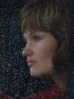 Girl looks thru waterdropped widow glass