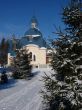 Winter snowy landscape with fur-trees and church