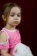 The small offended girl with a toy