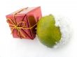 Tangerine and a christmas gift on snow