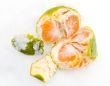 Open tangerine on snow
