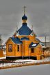 Russian wooden church with a dome and crosses