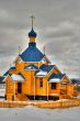 Russian wooden church with a dome and crosses