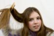 Portrait of the young girl combing hair