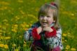 Smiling dirl in dandelion field