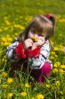 girl is smelling dandelion