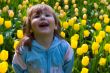 Laughting girl in tulips