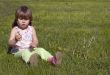 Little girl and dandelion