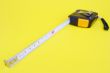 tape measure isolated on yellow
