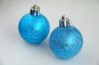 Two blue christmas bulbs