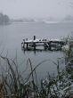 First season snowfall on riverside water