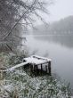 First season snowfall on riverside water