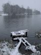 First season snowfall on riverside water