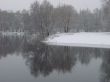 First season snowfall on riverside water